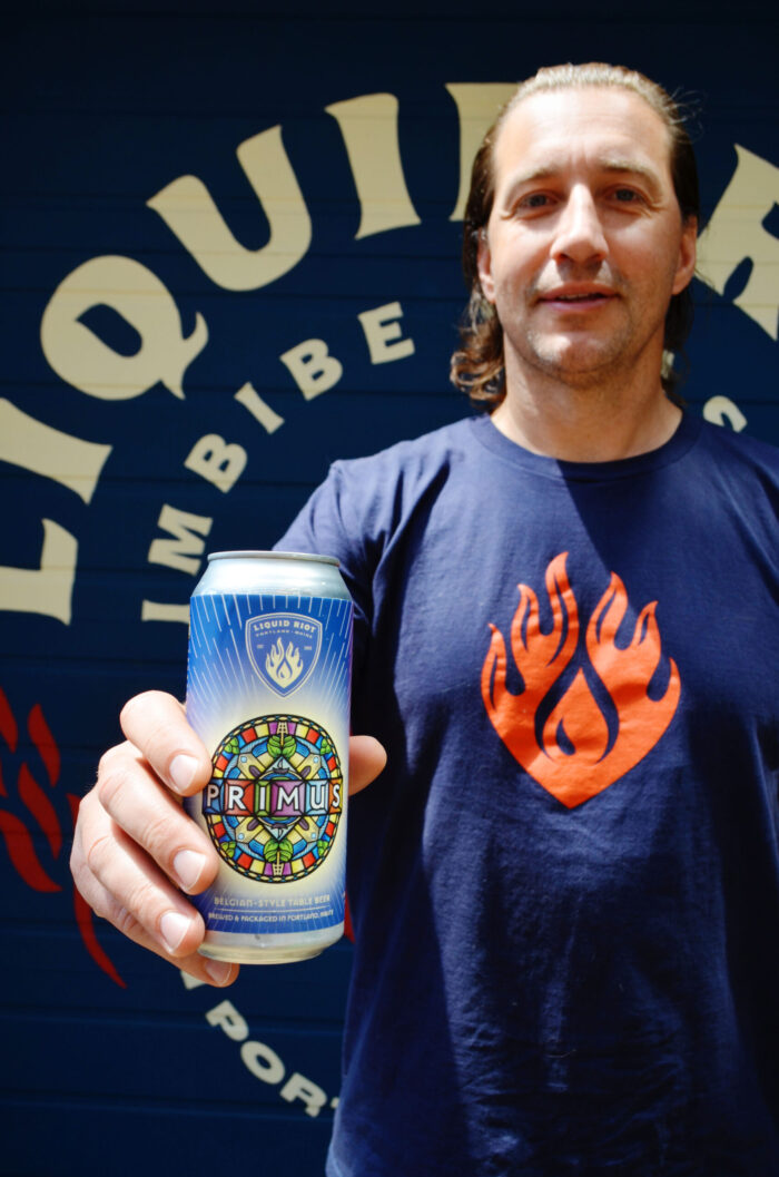 Founder Eric Michaud holding a can of Primus
