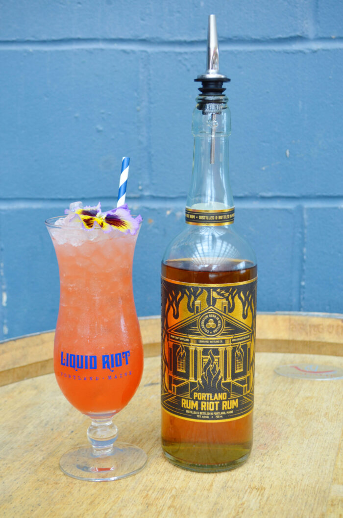 Jungle Bird cocktail served next to Rum Riot Rum bottle